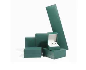 Detailed view of dark green textured jewelry boxes showing various sizes and white lining.