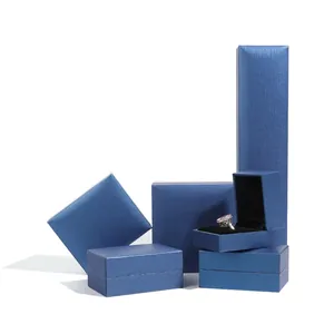 Premium blue textured paper jewelry boxes set for rings and pendants on white background