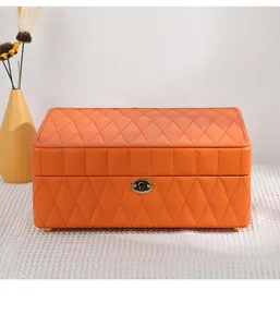 Detailed close-up view of a premium orange quilted leather jewelry box with golden lock
