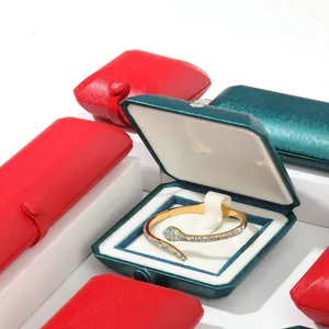 Vintage button-snap jewelry boxes in red and teal silk texture for bracelet and ring storage