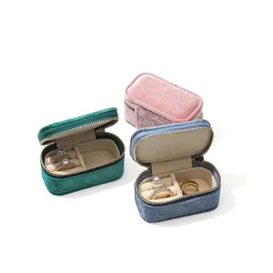 Portable mini velvet jewelry box organizers in pink, green, and blue colors for travel