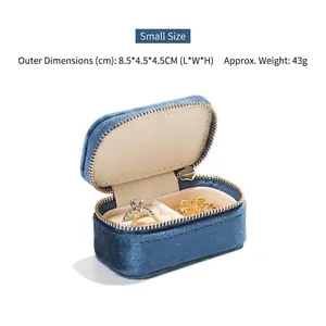 Mini blue velvet jewelry box detail showing compact size and ring storage