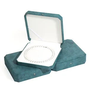 Elegant octagonal teal jewelry box for pearl necklaces, luxury gift packaging.