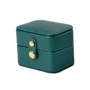 Compact dark green faux leather jewelry box with double gold snap buttons for rings