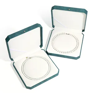 Two teal octagonal pearl necklace gift boxes with elegant white velvet interior