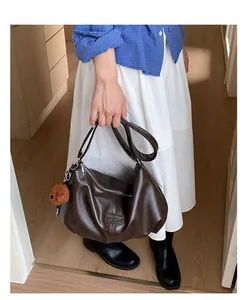 Vintage brown ruched leather shoulder bag with a cute teddy bear charm for daily use
