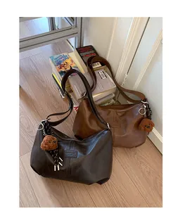 Two vintage-style large capacity shoulder bags in brown and dark chocolate colors.