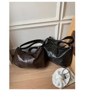 Retro high-capacity shoulder bags in dark brown and black colors with a vintage minimalist aesthetic