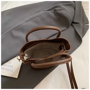 Interior view of a chic brown textured leather bucket bag with a zipper pocket detail