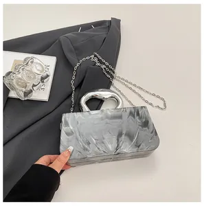 Macro detail of ice-crack marble acrylic box bag with silver organic handle