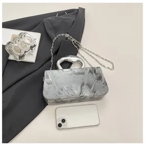 Detail view of grey ice-crack pattern acrylic box bag with stylish silver chain strap