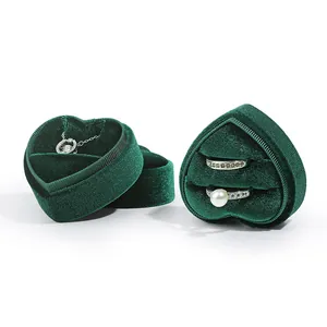 Elegant heart-shaped green velvet jewelry box for rings and pendants on white background