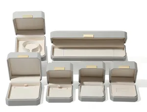Set of various grey octagonal PU leather jewelry boxes for rings and necklaces.