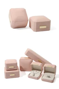 Detail view of octagonal pink velvet jewelry boxes showing ring and necklace storage