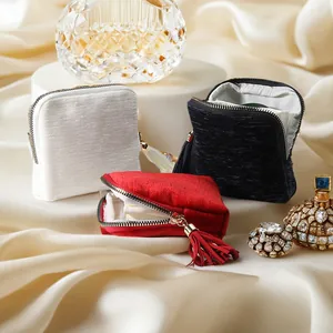 Elegant silk-textured jewelry storage pouches with decorative tassels for rings and necklaces
