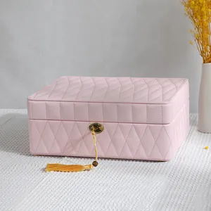 Large pink diamond quilted jewelry storage box with decorative gold tassel