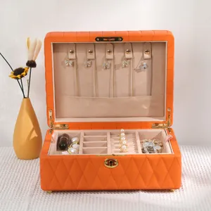 Large orange diamond quilted jewelry box featuring multi-layer storage compartments.