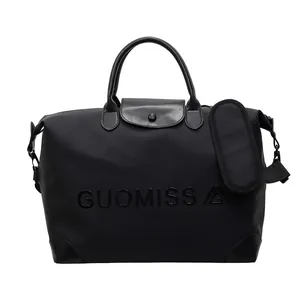 Detailed front view of a large black multifunctional travel bag with embossed letters.
