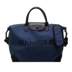 Large capacity navy blue travel bag with black leather handles and GUOMISS logo