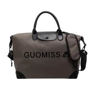 Detailed front view of the large capacity travel bag with black GUOMISS letter print