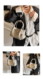 Detailed view of fashionable silver litchi grain bucket bag with chain strap and heart charm
