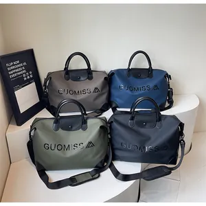 Set of four large capacity travel duffel bags in various colors with GUOMISS print