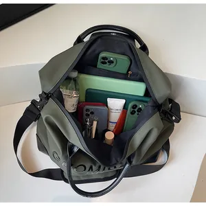 Detailed view of olive green travel bag showing large capacity interior with various essentials.