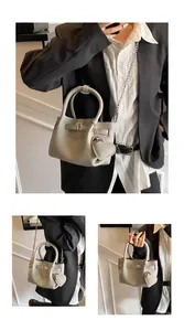 Detail view of fashion litchi pattern bucket bag with a stylish heart-shaped charm.