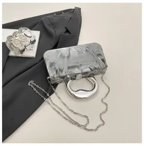 Detailed macro shot of grey ice-crackle marble acrylic box bag with silver handle
