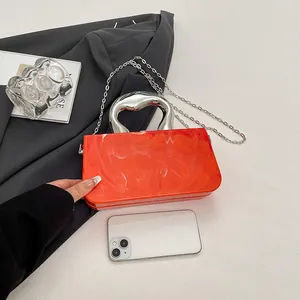 Elegant orange acrylic box handbag featuring ice crack texture and silver handle