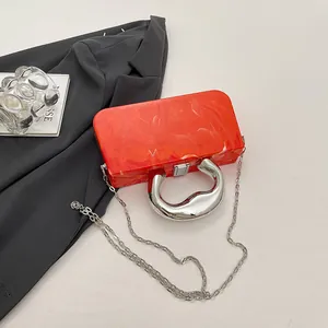 Elegant orange acrylic box clutch featuring ice-crack texture and chic silver handle