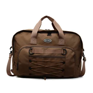 Large capacity brown functional travel duffel bag featuring front elastic cord details and logo