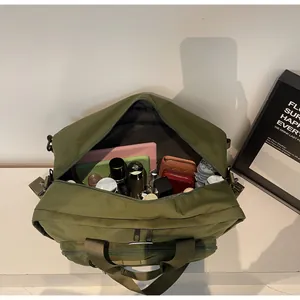 Close-up view showing the large capacity interior of a green functional travel messenger bag