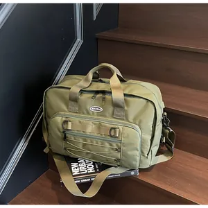 Large olive green techwear messenger bag for travel and gym, urban style on stairs