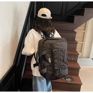 Large capacity black techwear backpack for travel and outdoor sports shown in lifestyle setting