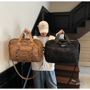 Large capacity techwear travel messenger bags in brown and black shown by Asian model