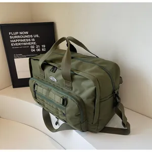 Detail view of large olive green functional messenger bag with webbing accents.