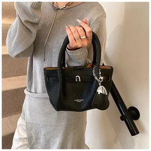 Detailed view of the black lychee-textured leather bucket bag with silver-tone hardware