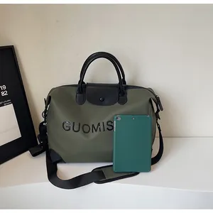 Olive green large capacity travel bag size comparison with a green tablet on white