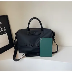 Large capacity black travel bag shown next to a tablet for size comparison