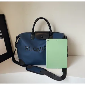 Navy blue travel bag size comparison with a light green tablet for scale