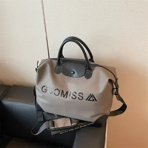 Large capacity khaki travel bag featuring GUOMISS letter print and black leather handles