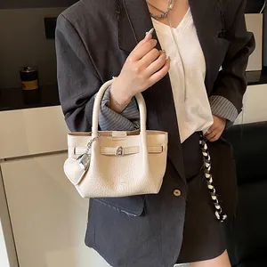 Minimalist beige lychee texture bucket bag with heart charm