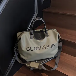 Large capacity olive green travel bag with black leather trim and letter print.