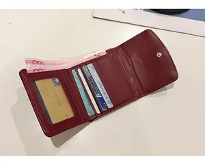 Interior view of burgundy quilted tri-fold wallet showing card slots and cash slot