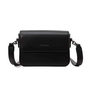 Detailed front view of a minimalist black vintage textured crossbody square bag for women