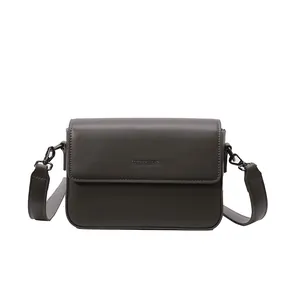 Detailed view of a retro dark brown small square crossbody bag for women with flap