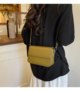Chic olive green retro small square crossbody bag featured in a cafe lifestyle setting.