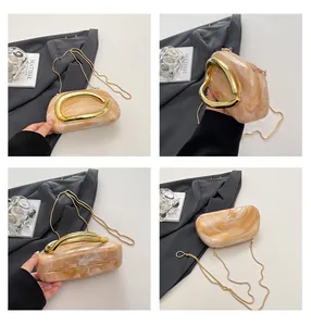 Detailed multi-angle views of a marbled evening clutch with vintage gold handle and chain.