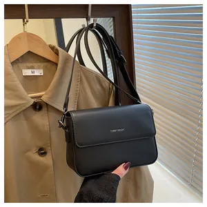 Detail view of a black retro small square crossbody bag with Tommy Knight logo